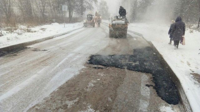 Под Тулой асфальт кладут на заснеженную дорогу